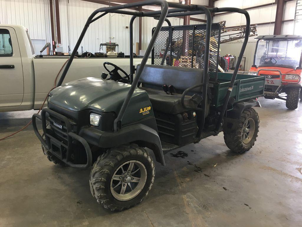 Used green 2005 Kawasaki Motors Corp Mule 3010 UTV in garage. 